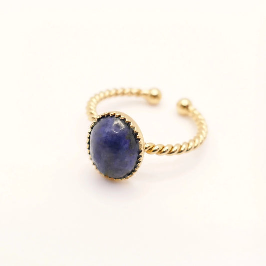 Bague femme avec anneau en or torsadé et pierre de Lapis Lazuli bleue sur fond blanc